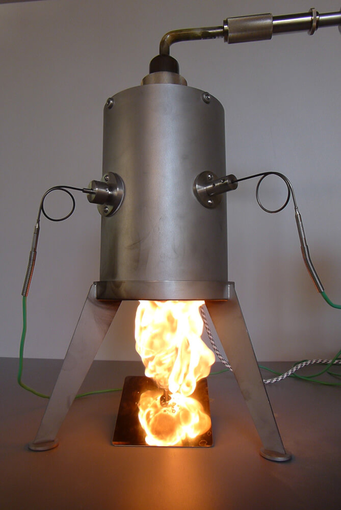 Material testing equipment showing MIT combustible dust ignition temperature test apparatus with flame