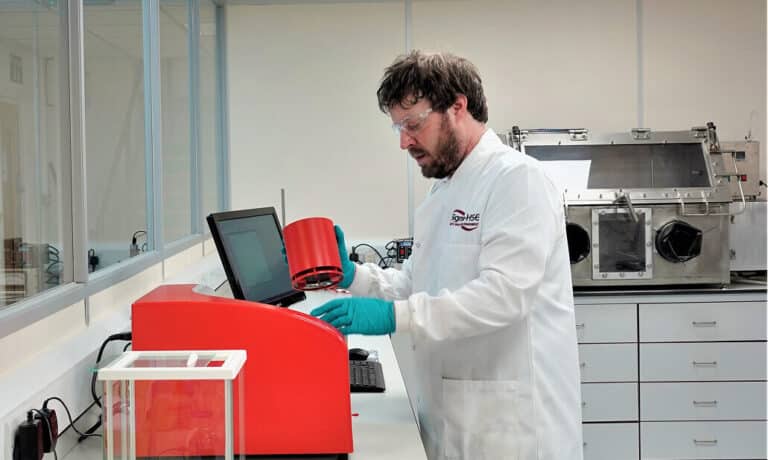 Laboratory technician performing Differential Scanning Calorimetry (DSC) thermal analysis for chemical process evaluation