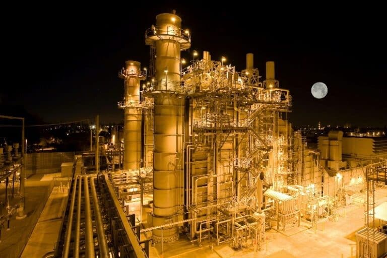 Industrial chemical plant at night representing thermal stability and calorimetry testing in process safety