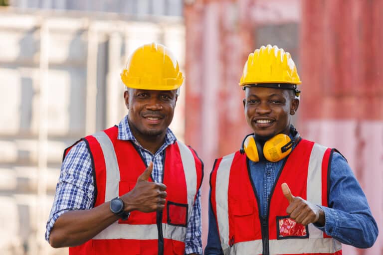 Two industrial workers wearing safety helmets and vests, representing leadership and culture in process safety management.
