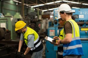 Workers conducting safety checks in an industrial facility—relevant to combustible dust hazard management